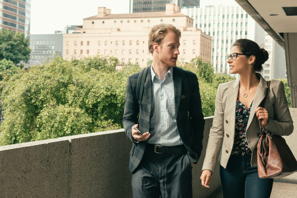 Businessman and woman walking and talking, Los Angeles, USA