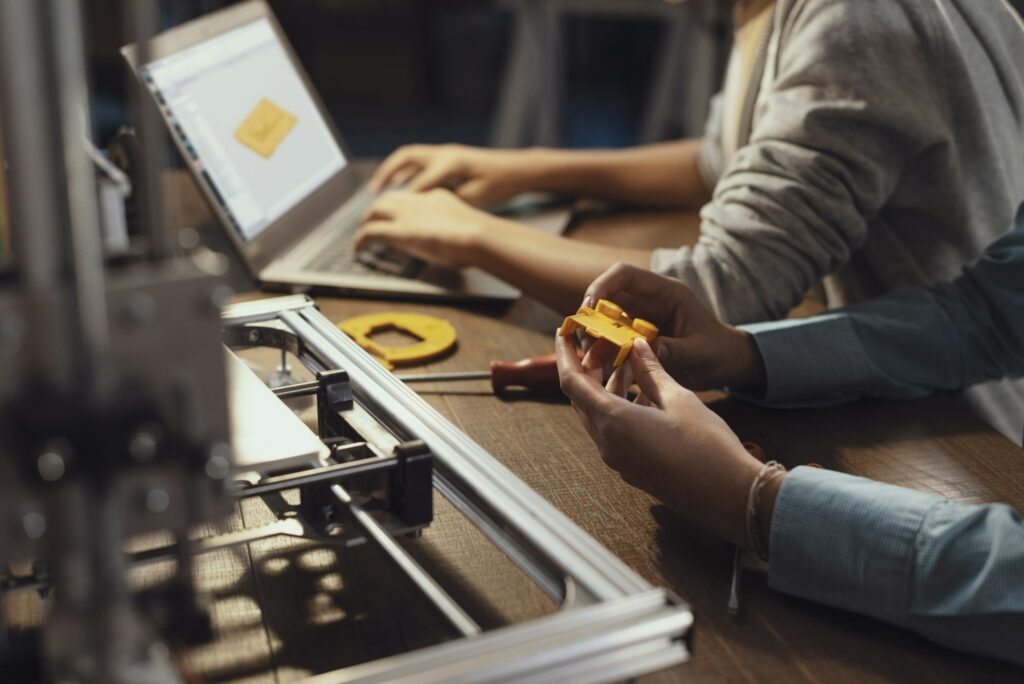 Students using a 3D printer and printing prototypes